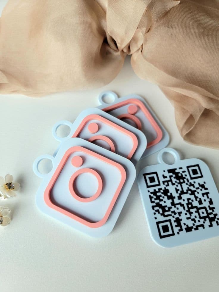 Pastel camera-icon keyrings with QR codes